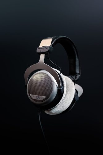 Studio portrait of Beyerdynamic DT 880 headphones with soft focus on textured earpads and grill.