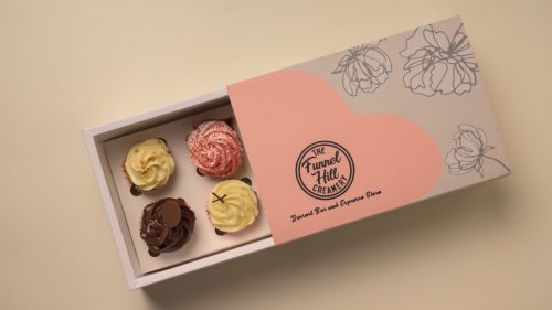 Open The Funnel Hill Creamery gift box with multiple assorted frosted cupcakes.
